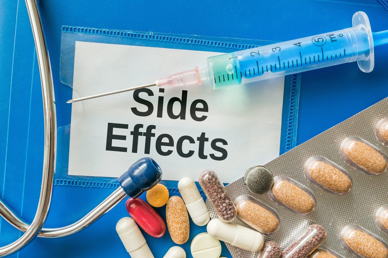 Side effects of medicine concept. A lot of pills and drugs and syringe around.