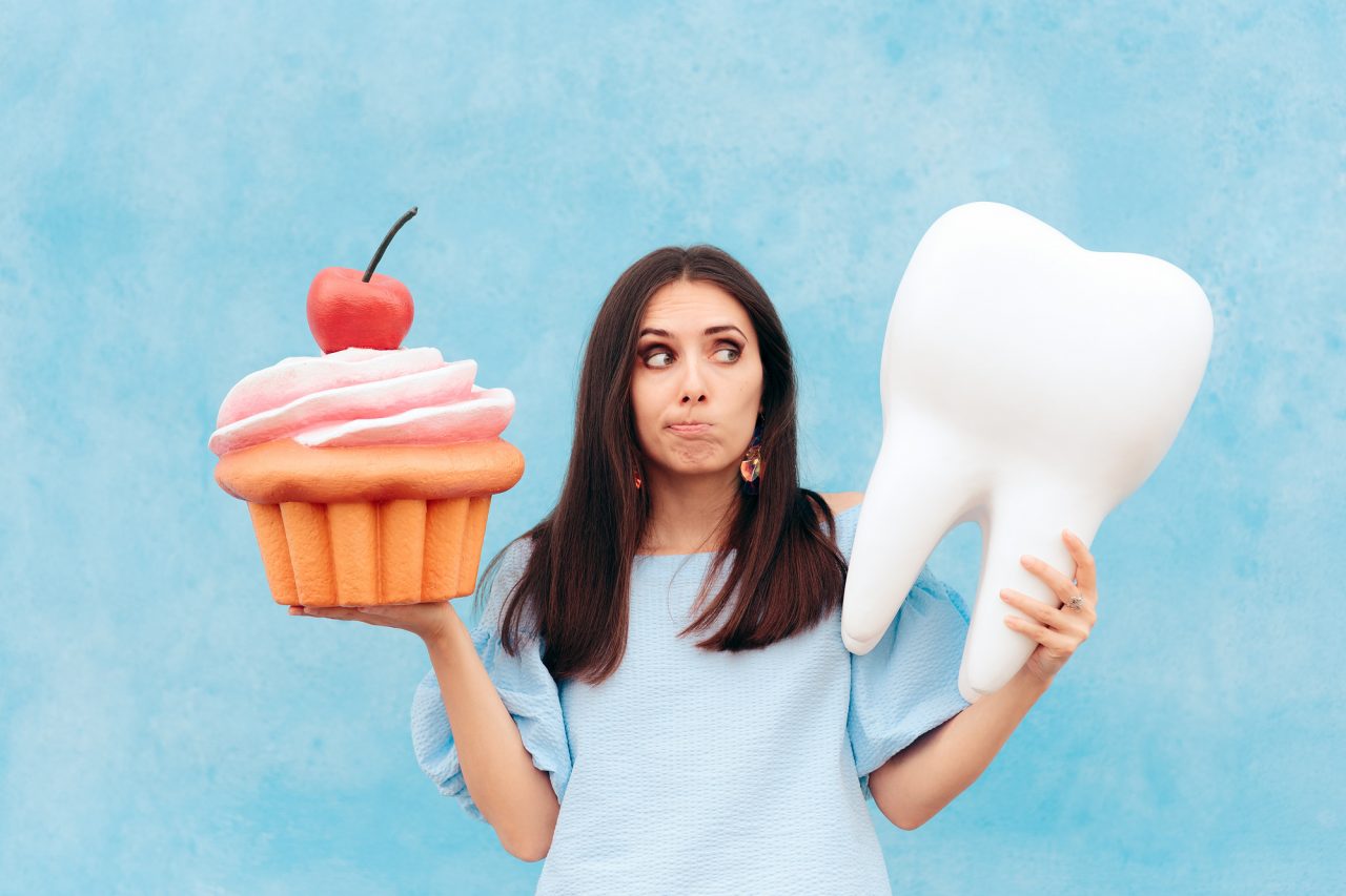 Funny Woman Holding Big Cupcake and Tooth