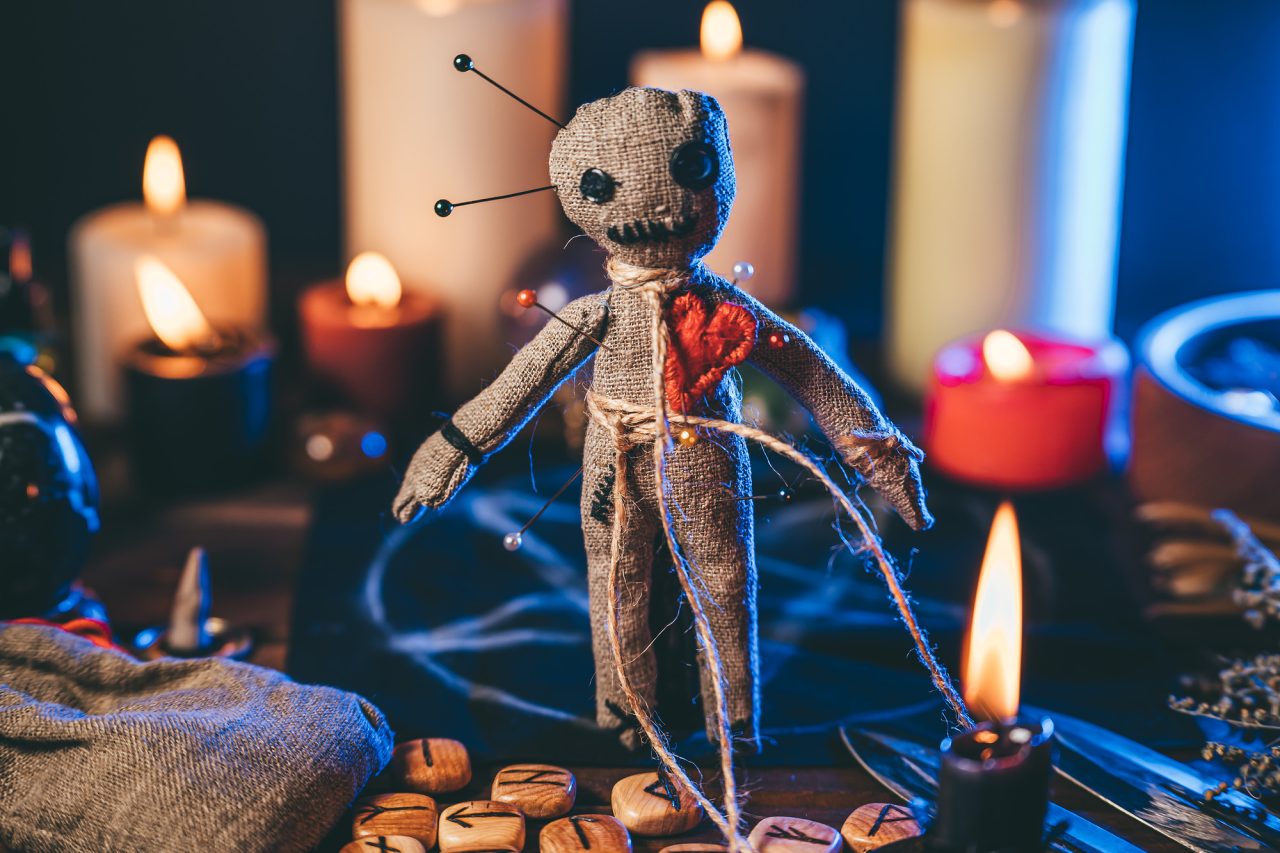 Voodoo doll studded with needles